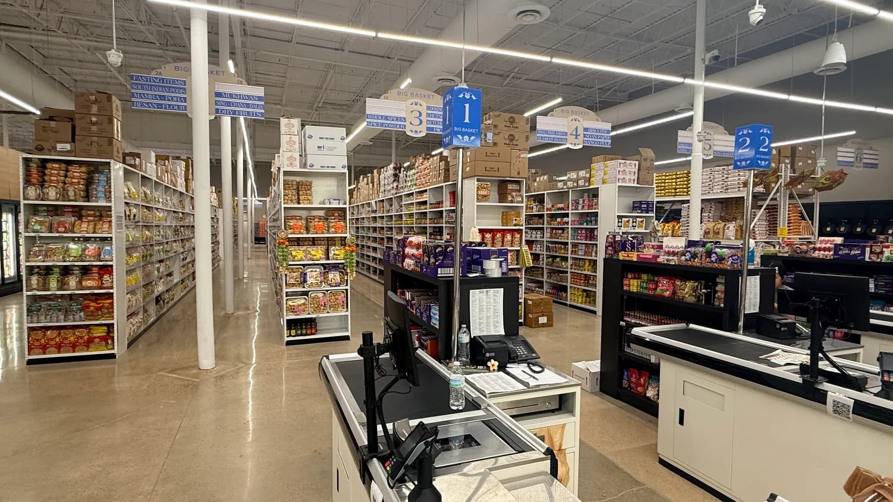 Numbered grocery aisles and checkout counters inside Big Basket